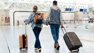 Couple at the airport walking to board stock photo